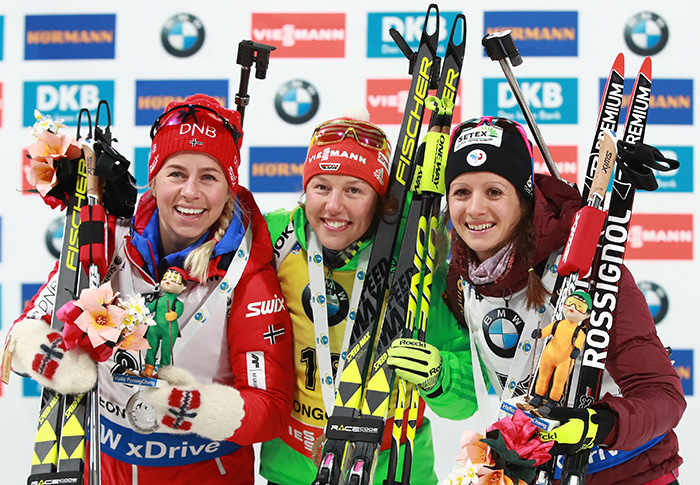 Laura Dahlmeier of Germany (C) poses for a photo with Tiril Eckhoff of Norway (L) and Anais Chevalier of France after winning the women's sprint at IBU Biathlon World Cup in PyeongChang, Gangwon Province, on March 2, 2017.